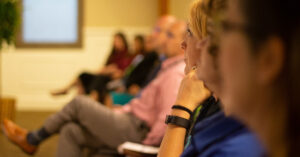 an audience of people sitting listening to an event