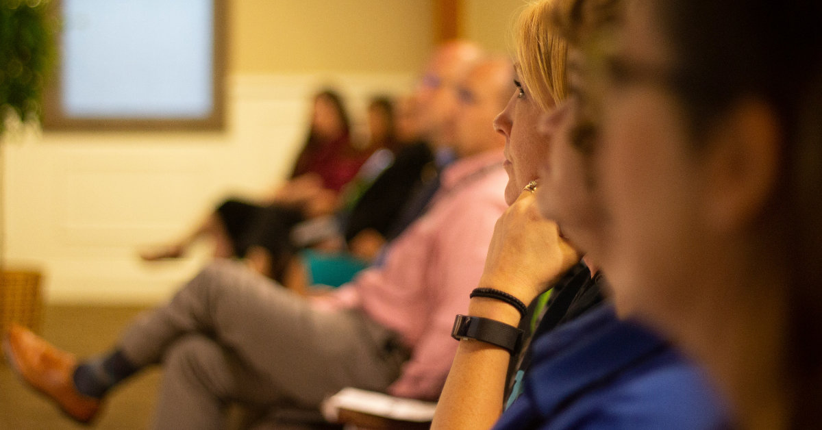 an audience of people sitting listening to an event