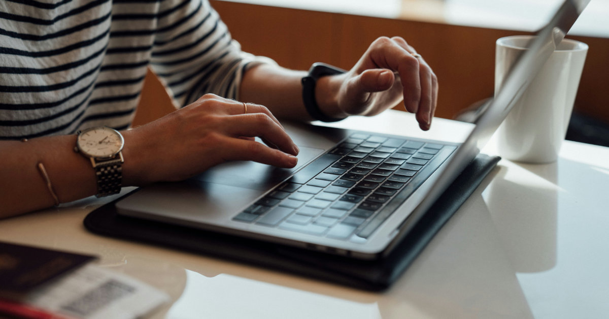 hands using a laptop kepboard