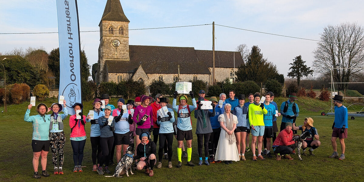 A group of runners stand outside St Mary's church in Overton.