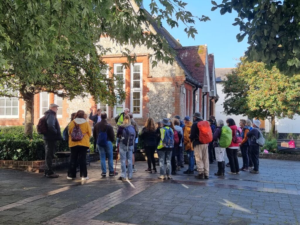 A group of walkers outside Overton community centre listening to information being shared by members of the Jane Austen Trails team